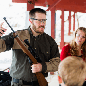 Guardian teacher going over weapon safety.